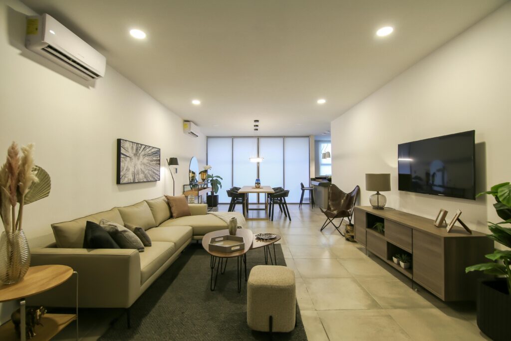 Elegant modern open-plan living and dining room with cozy furniture and warm lighting.